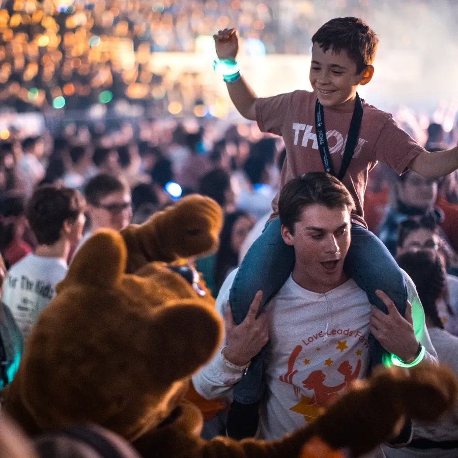 A Four Diamonds child on shoulders at THON